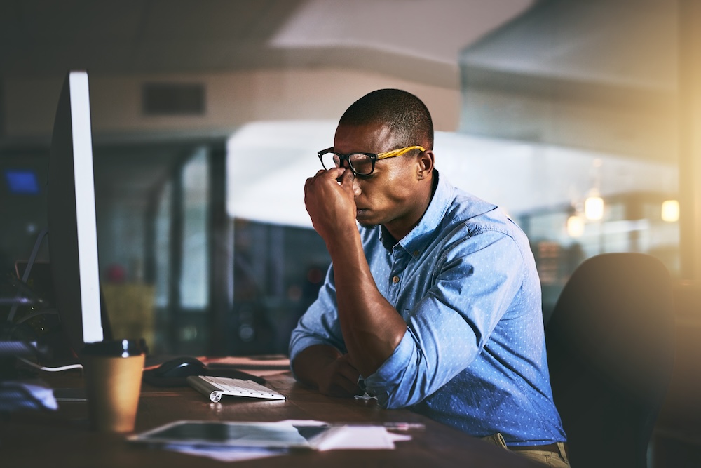 Man at office desk with stress